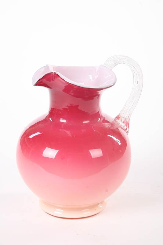 Appraisal: PEACHBLOW PITCHER Ball-form with a white interior and clear ribbed