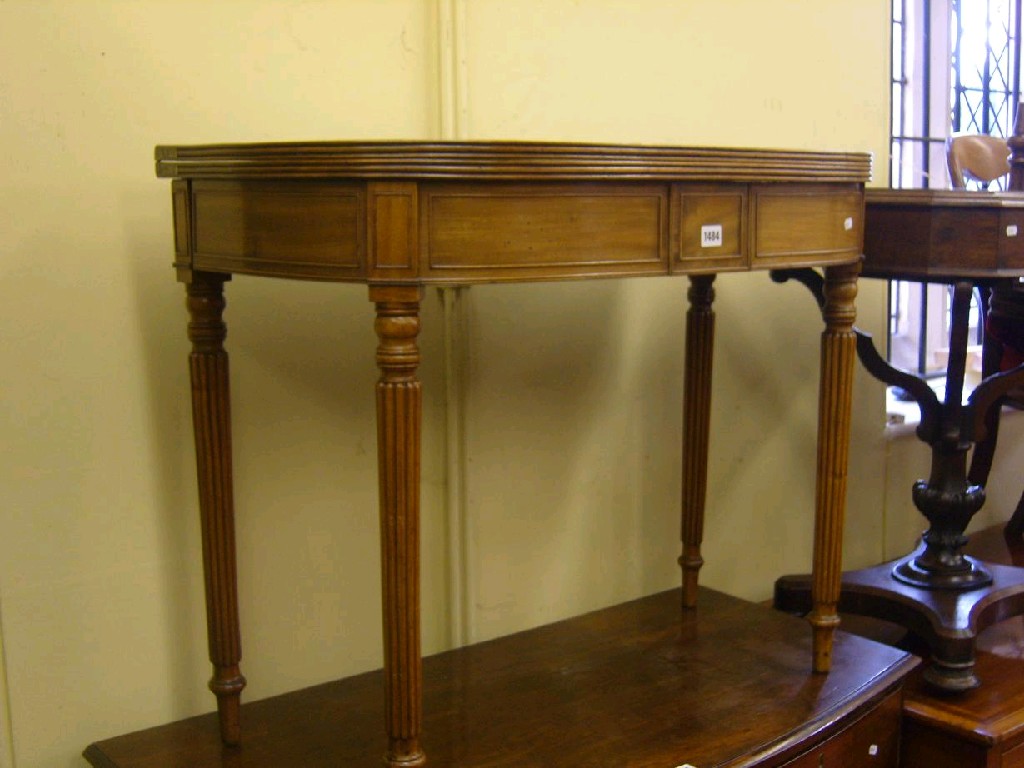 Appraisal: A Georgian mahogany demi lune fold over top tea table