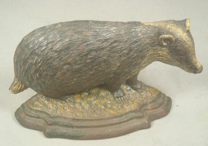 Appraisal: Cast iron doorstop brown and yellow badger on grassy base