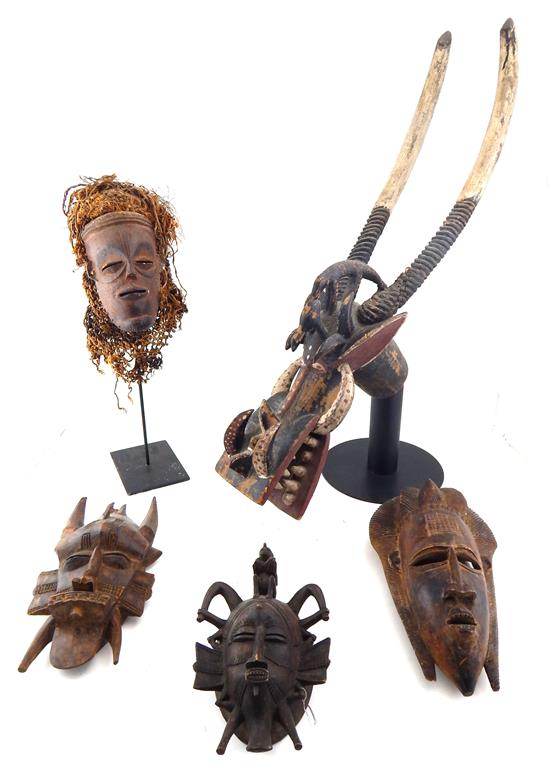 Appraisal: TRIBAL Five African carvings four masks and one wall hanging