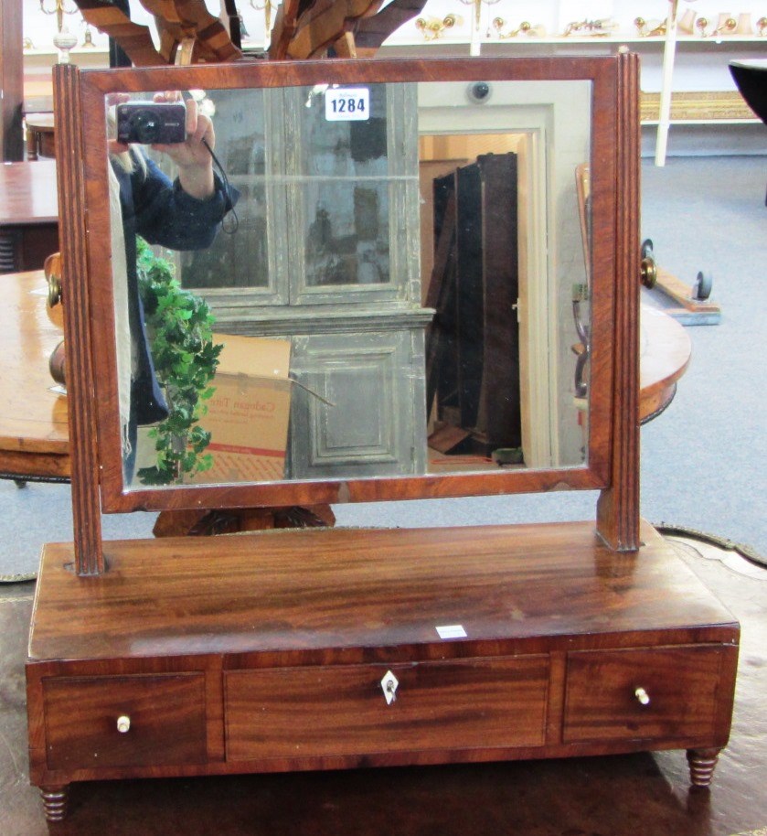 Appraisal: A George III mahogany toilet mirror with three drawer base