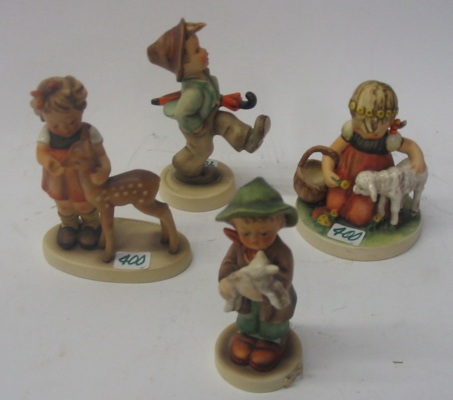 Appraisal: A GROUP OF FOUR GERMAN HUMMEL FIGURES Happy Traveler HUM