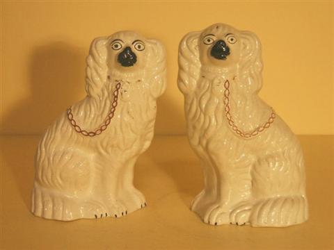 Appraisal: PAIR OF STAFFORDSHIRE DOGS Each covered in a creamy white