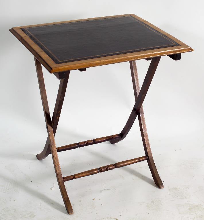 Appraisal: EDWARDIAN LEATHER-INSET MAHOGANY FOLDING TABLE the moulded rectangular top raised