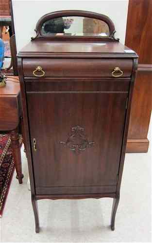 Appraisal: MAHOGANY MUSIC CABINET American c having a mirror crest over