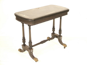 Appraisal: A Victorian ebonised foldover card table the ivory inlaid rounded