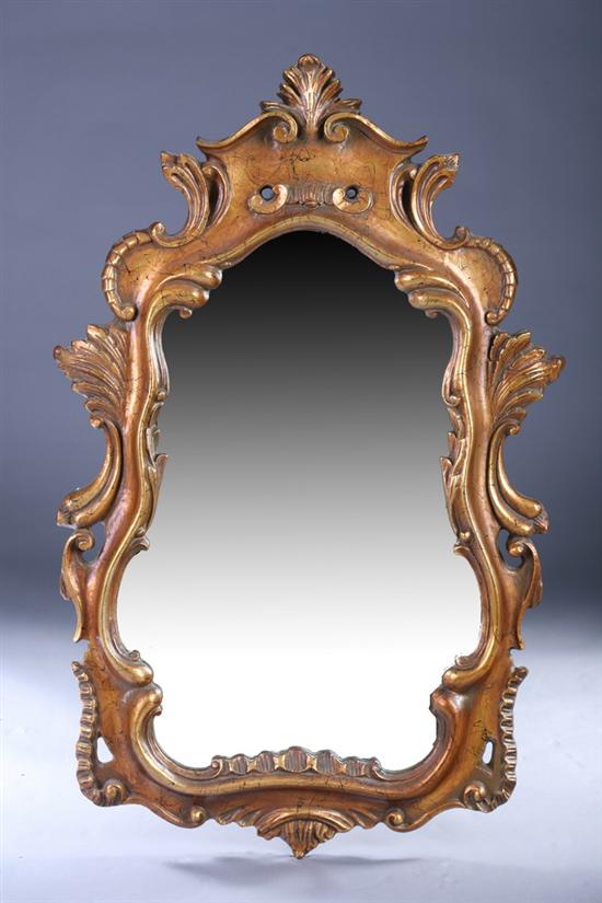 Appraisal: CONTINENTAL ROCOCO-STYLE GILT-WOOD WALL MIRROR th century Foliate-crested scrolling pediment