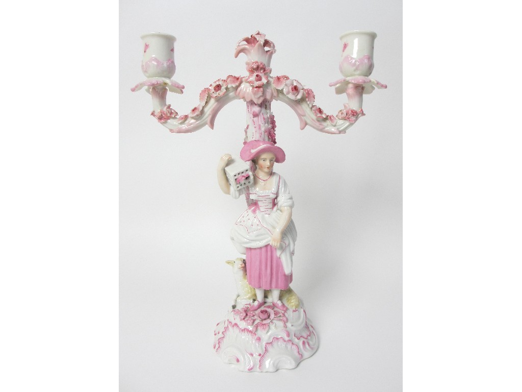 Appraisal: A Continental porcelain candelabra modelled with a woman holding a