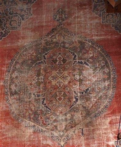 Appraisal: A ZEIGLER RED GROUND CARPET decorated a central foliate medallion