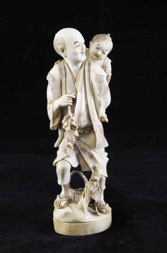 Appraisal: A Japanese ivory group of a man carrying a child