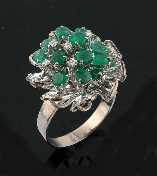 Appraisal: An emerald and diamond cluster ring The abstract cluster set