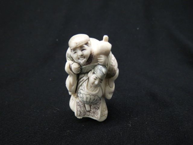 Appraisal: Carved Ivory Netsuke of Two Men one on shoulders of