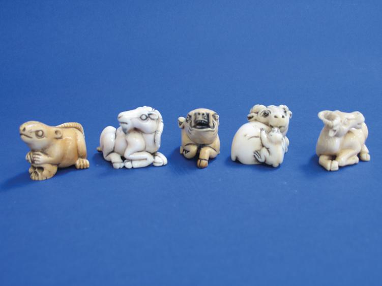 Appraisal: A JAPANESE IVORY NETSUKE in the form of a recumbent