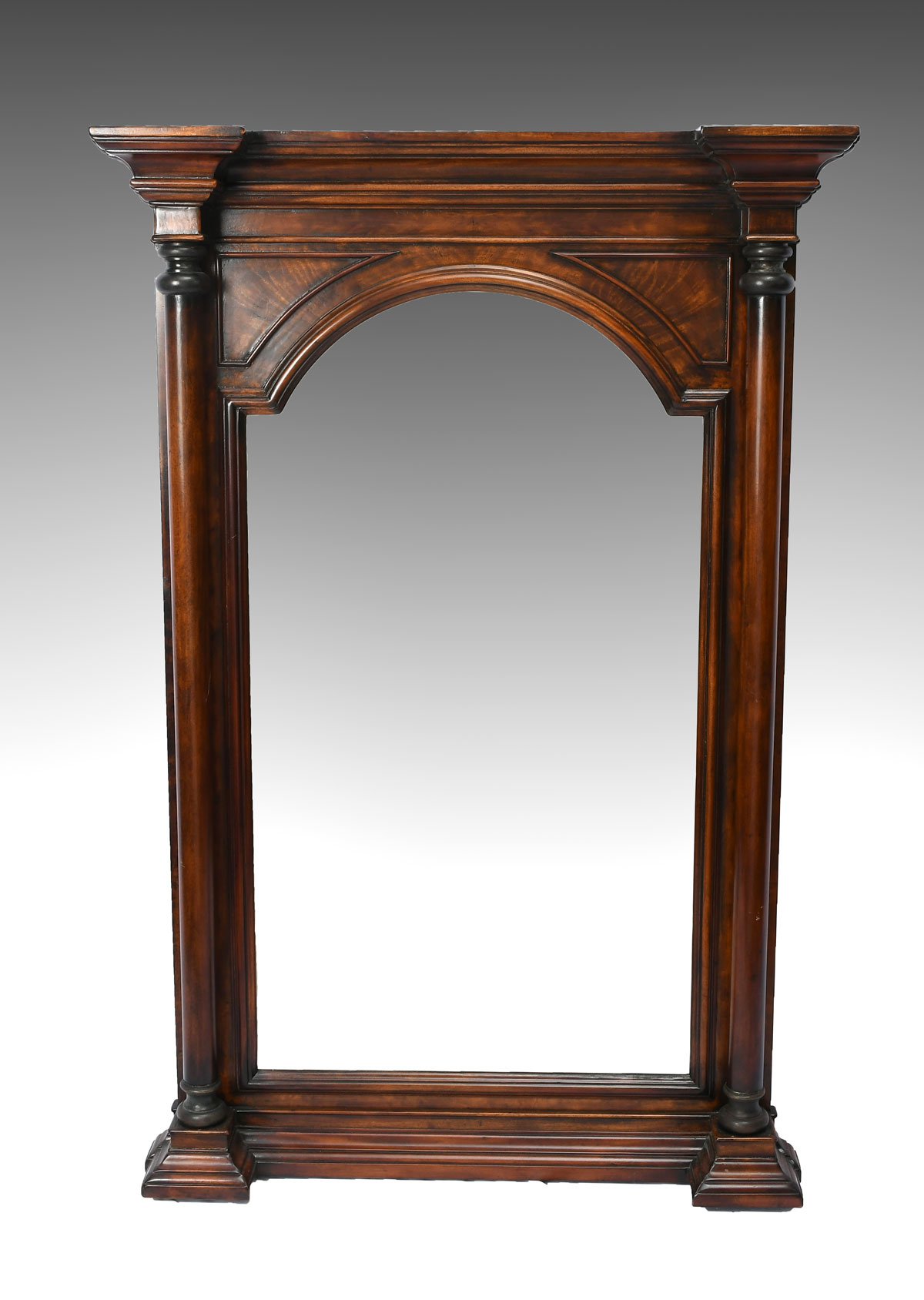 Appraisal: CARVED MAHOGANY MIRROR Beveled arch top mirror flanked by turned