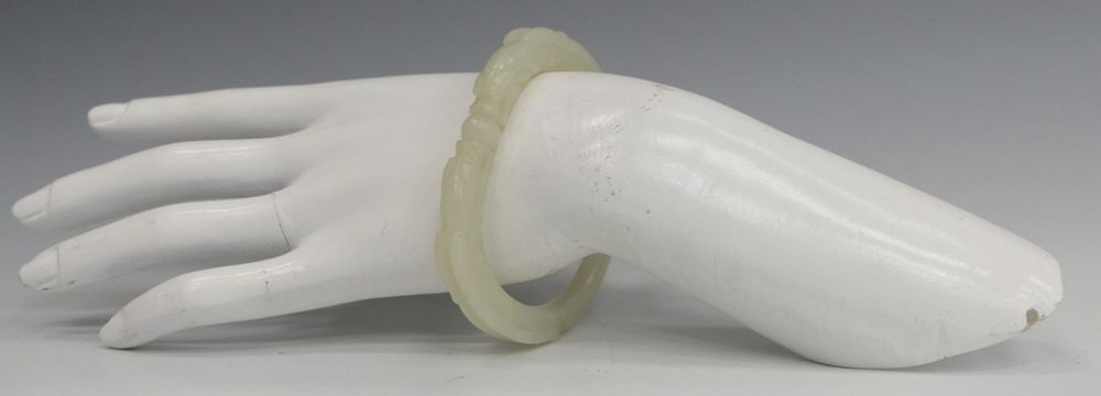 Appraisal: CHINESE WHITE JADE RETICULATED DRAGONS BANGLE A finely carved Chinese