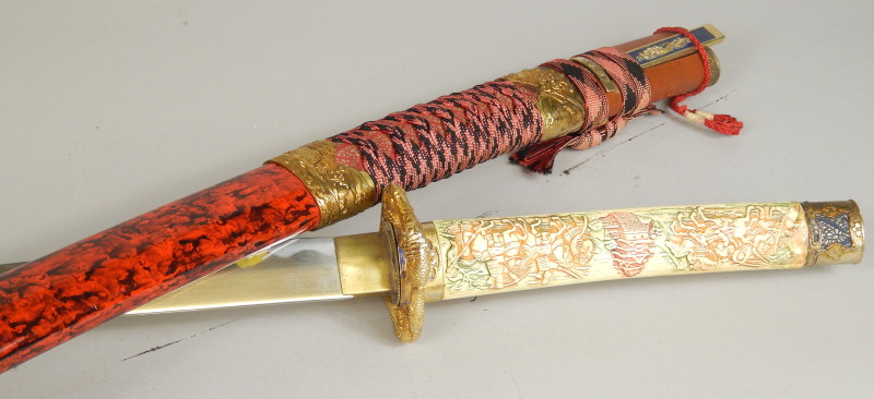 Appraisal: A reproduction Japanese sword with simulated ivory handle lacquered scabbard