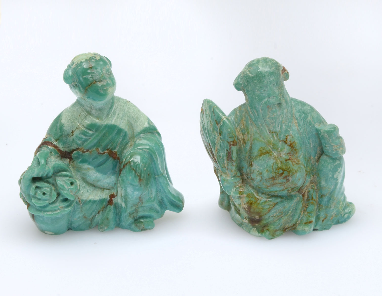 Appraisal: CHINESE CARVED TURQUOISE IMMORTALS Comprising one female with a basket