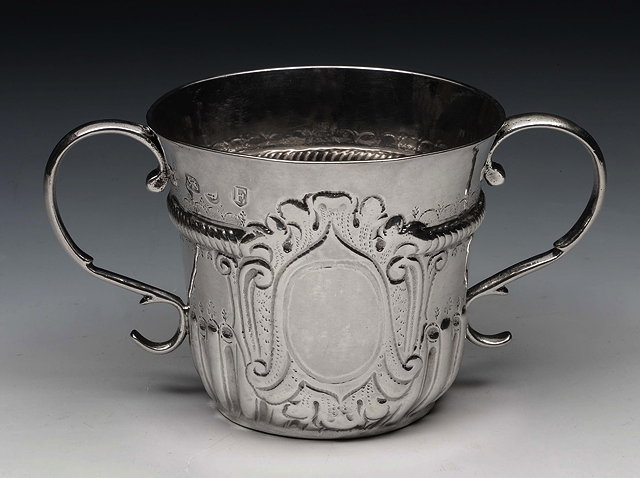 Appraisal: A GEORGE I SILVER PORRINGER with fluted lower body gadrooned