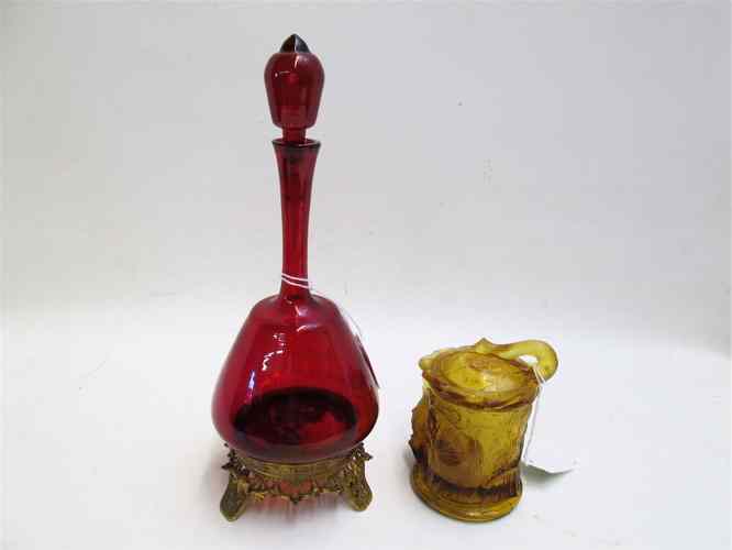 Appraisal: TWO COLLECTIBLES a ruby red glass cruet with original stopper