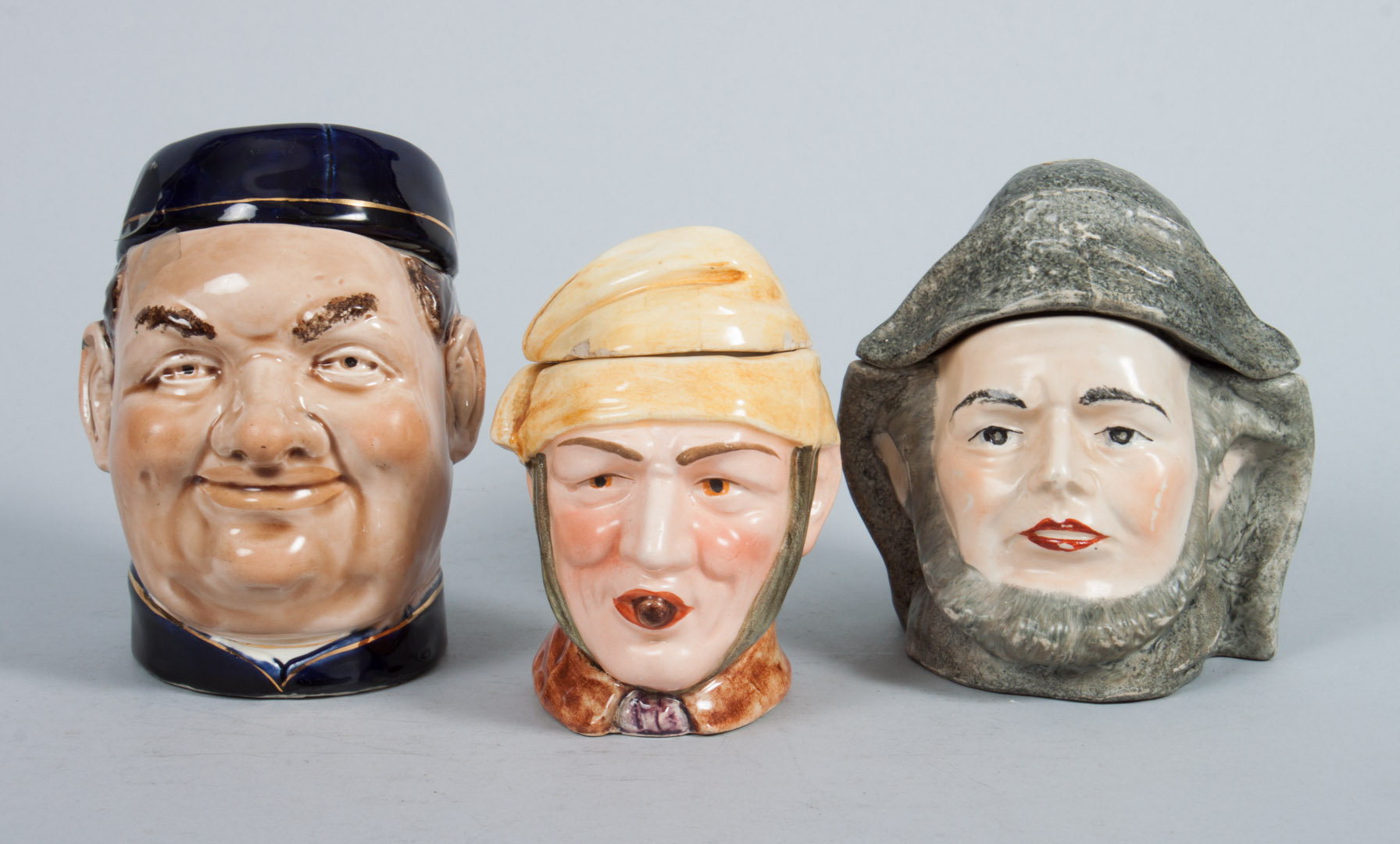 Appraisal: Three German ceramic character jars early th century including Old