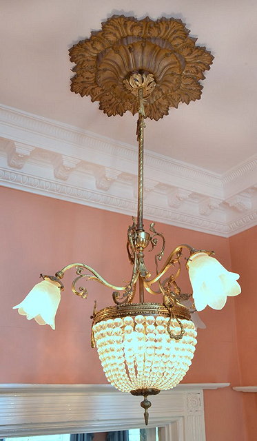 Appraisal: AN EDWARDIAN GILT METAL CENTRE LIGHT with three branches having