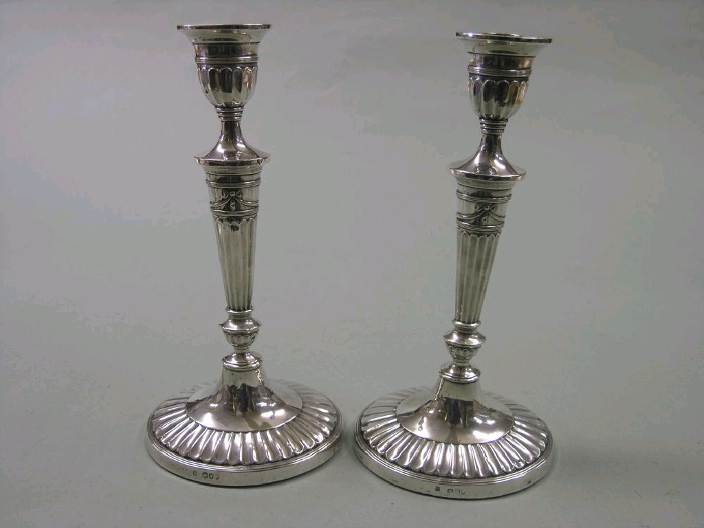 Appraisal: A pair of late Victorian silver candlesticks classical tapering form