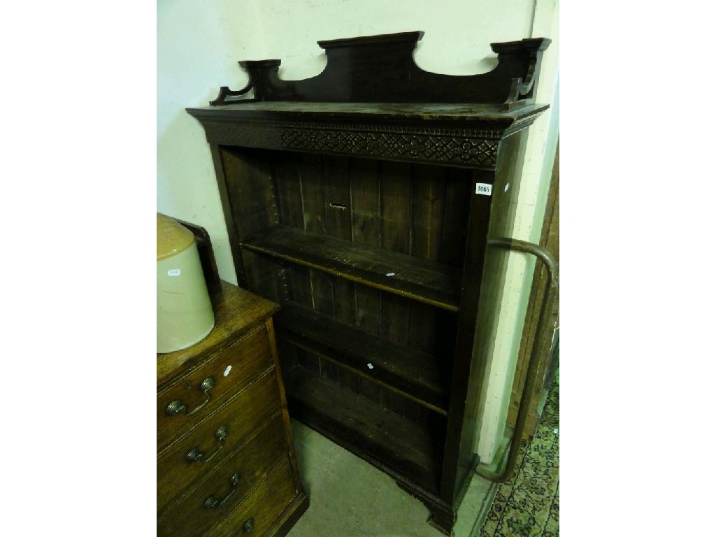 Appraisal: An Edwardian stained pine and walnut freestanding open bookcase with