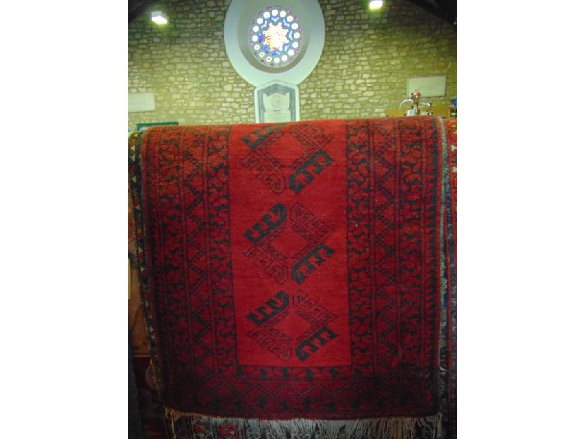 Appraisal: A small eastern style wool work rug with deep red