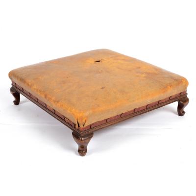 Appraisal: A beechwood footstool with a square leather upholstered seat on