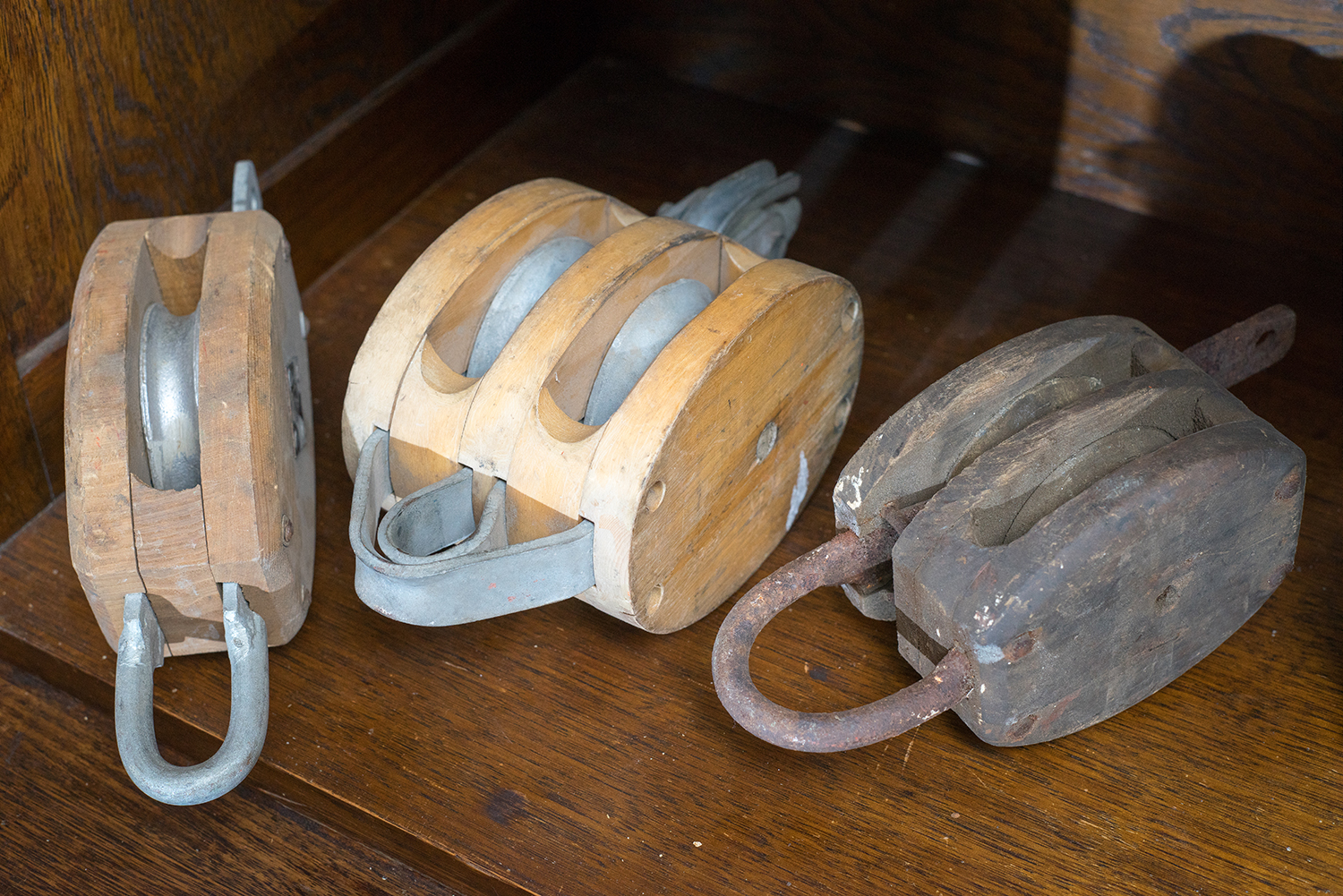 Appraisal: THREE VINTAGE INDUSTRIALS PULLEYS Timber with metal fittings varying sizes