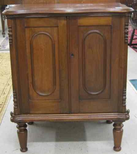 Appraisal: A VICTORIAN WALNUT SIDE CABINET American c the front featuring