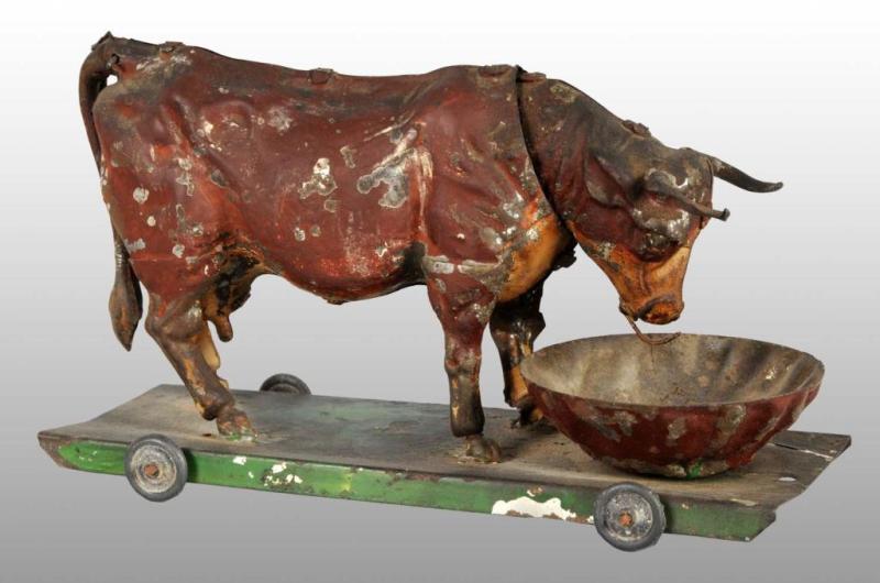 Appraisal: Tin Hand-Painted Bull Platform Wind-Up Toy Description German Working When