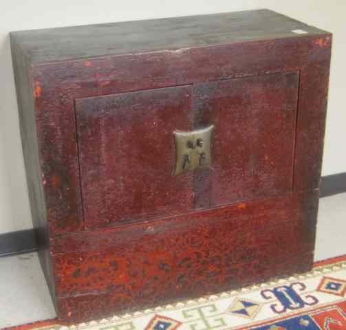 Appraisal: CHINESE STORAGE CABINET centering two doors and having a distressed