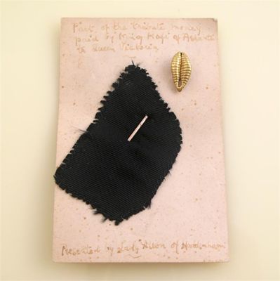 Appraisal: A gold stick pin with gold cowrie shell With a