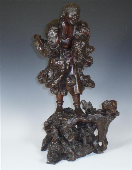 Appraisal: A th century Chinese root wood carving the standing figure