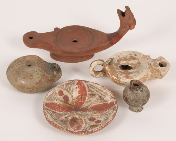 Appraisal: Three Roman terracotta oil lamps one ending in ram's head