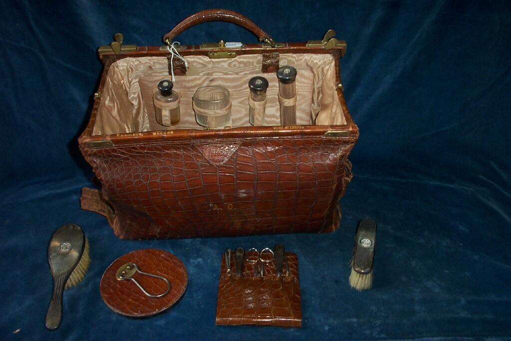 Appraisal: A crocodile skin leather travelling bag with fitted interior with