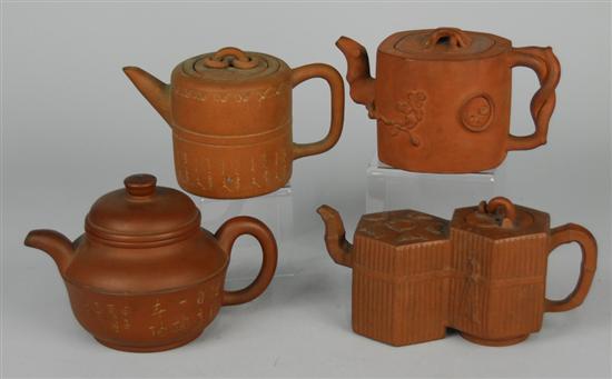 Appraisal: FOUR CHINESE YIXING TEAPOTS one with bat and fruit decoration