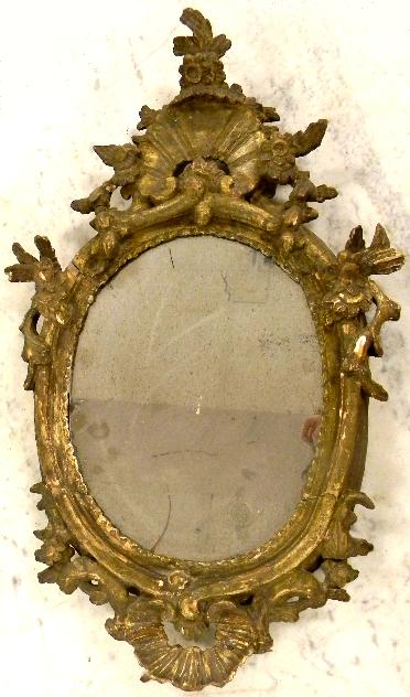 Appraisal: French oval mirror with shell crest with floral and scroll