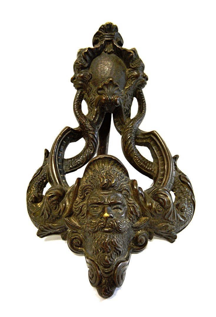 Appraisal: A Georgian bronze door knocker with shell scroll finial over