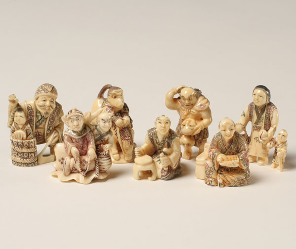 Appraisal: Japanese carved netsukes merchants and monkey Tallest H