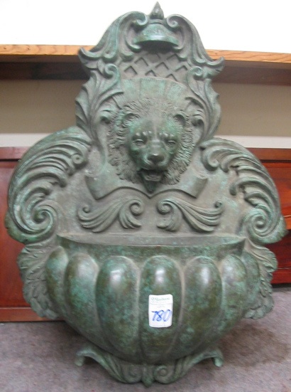 Appraisal: A CLASSIC BRONZE WALL FOUNTAIN with spouting lion mask over