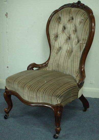 Appraisal: A Victorian upholstered armchair with deep button back having an