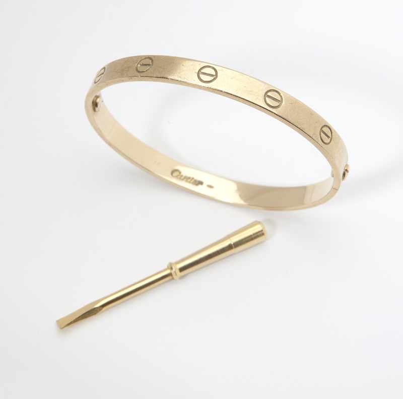 Appraisal: A gold ''Love'' bangle by Cartier Signed ''Cartier'' and numbered