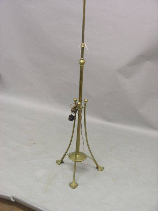 Appraisal: An Art Nouveau brass standard lamp on spade-form tripod base