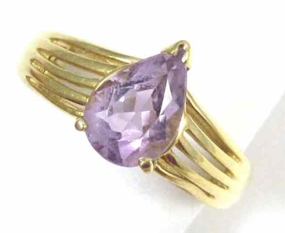 Appraisal: AMETHYST AND FOURTEEN KARAT GOLD RING set with a single