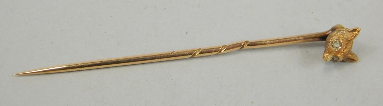 Appraisal: A fox head stick pin diamond chip eyes yellow metal