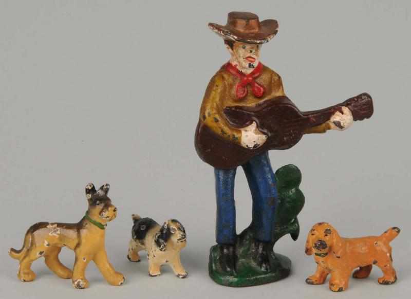 Appraisal: Lot of Cast Iron Figural Pieces Description Includes cowboy playing