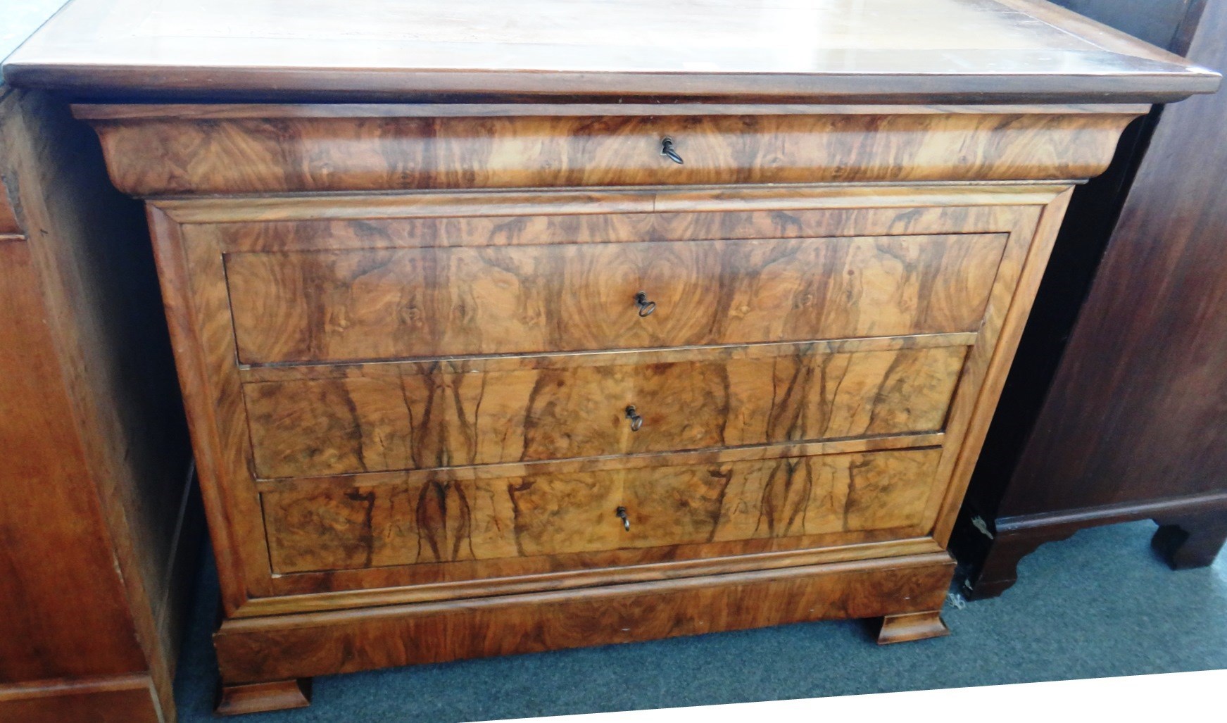 Appraisal: A th century French figured walnut four drawer commode on