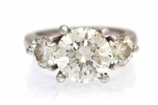 Appraisal: A Platinum and Diamond Three Stone Ring containing one round